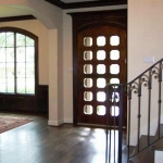 Foyer - Approx 14 x 14 Custom door with inset window panes Hardwood floor Crown molding Wrought iron banister staircase Walk-in closet 21 ft Ceiling with Schoenbeck chandelier 