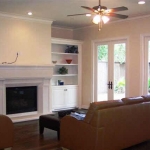 Second view of family room, showing bookshelves, closed storage and connections for TV.