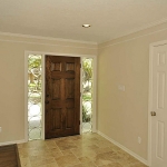 Entryway with tumbled travertine floor. Crown moldings and fresh paint throughout.