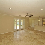 From entryway looking across expanse of beautiful Travertine to the patio doors and kitchen.