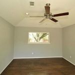 Master Bedroom with more gleaming hardwoods, ceiling fan, recessed lighting.