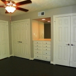 Bedroom three has a built in vanity. Again with wood floors, and access to the gardens.