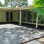 Extensive wood deck and covered patio on back of home.