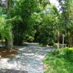 Another bench in the background. Extensive landscaping.