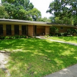 Street view, lots of windows and front porch to keep the summer rains off your guests.