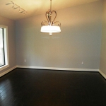 Dining room, beautiful contemporary chandelier. Open to the kitchen/breakfast room on the right.