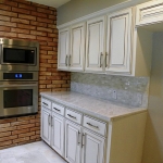 Additional white marble counters Stainless Steel microwave and oven.